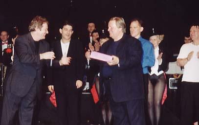 Comedian Jim Davidson presenting an award to Dave Lee for achieving £1M 