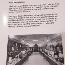 look clean and smart. The working he manager th an inspection by tt aculate Staff were expected to | ind an imm: day started at 7 30am wi Clean fingernails, polished shoes ai uniform were demanded nics which buttoned to the cruits and assistant salesmen he buttons had a number SO tified by the customers. An ic and put on when the Men wore double-breasted tu neck. The tunics of new re! had black buttons. One of t! the salesman could be iden’ apron was worn over the tun morning cleani