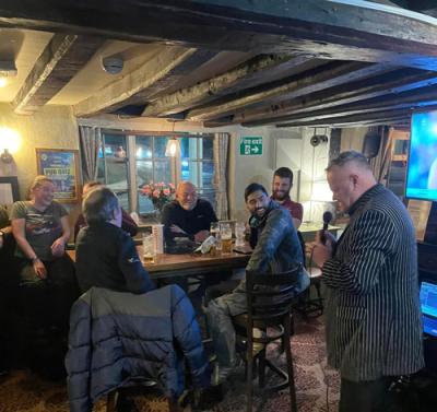 Adrian doing Stand up Comedy in a pub